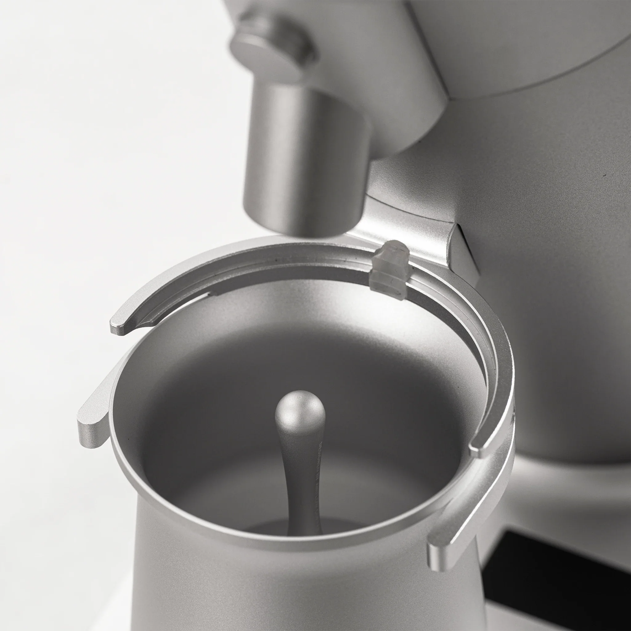 Close-up of the WPM ZP1 Single Dose Grinder's magnetic dosing cup and grind collar.
