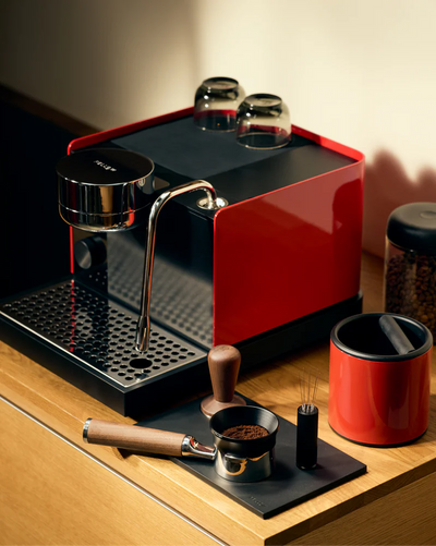 Cherry Red - Fellow Espresso Series 1  in Cherry Red with the sun lighting the machine and providing a great look vellutto.eu